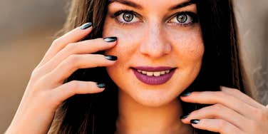 perfectionist woman smiling and thinking