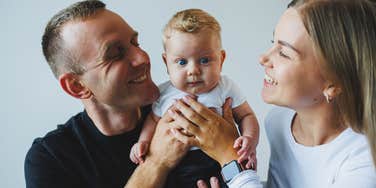 parents holding their baby