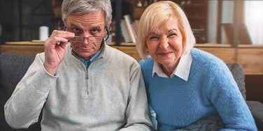 Boomer grandpa judging today's parenting while his wife smiles 