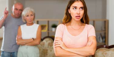 woman who is the family scapegoat being yelled at by parents