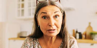 A woman recording a social media video with an air of expertise and confidence; illustrating the 'constant teacher' dynamic that can sometimes mask a deep-seated inability to admit fault or take responsibility.