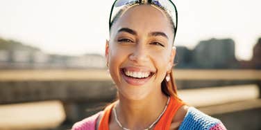portrait of smiling woman standing outside