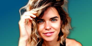 Highly intuitive young woman glowing warmly on a blue background