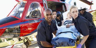 paramedics getting patient off a medevac flight on hospital's helipad