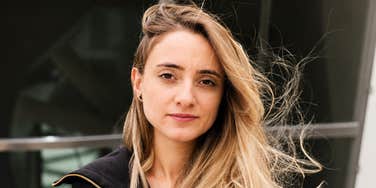 A portrait of a woman looking uneasy and defensive; illustrating the psychological impact of 'narcissistic devaluation' and the common behaviors—like gaslighting and goalpost-shifting—that define toxic relationships.