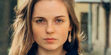 Woman who was yelled at a lot as child looking serious