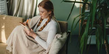 woman writing in a journal with handwriting that proves she's a good person