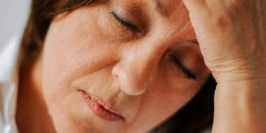 Woman experiences menopause symptoms.