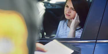 woman getting a ticket from a police officer
