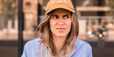 Young woman annoyed at her parents using offensive phrases 