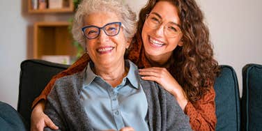 happy adult woman visiting her older mother smiling