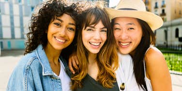 group of millennial women smiling unconcerned with status quo