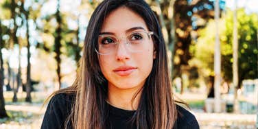 A woman showing visible signs of suspicion and discomfort while looking at someone off-camera; illustrating the 'social red flags' and behavioral cues that trigger an immediate sense of distrust.