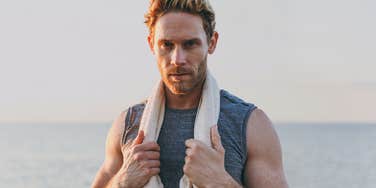 Vain-looking man takes himself seriously after a run on the beach