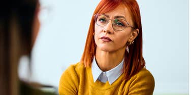 quiet woman listening intently to her friend speak