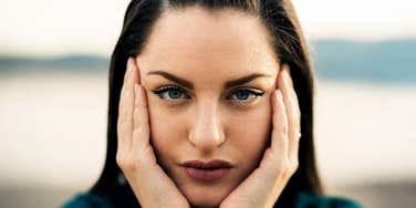 A devastated woman looking ahead deep contemplation; illustrating the initial stage of emotional repair after a significant breach of trust in a relationship.