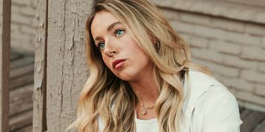 Woman who needs a break staring out into the distance looking numb 
