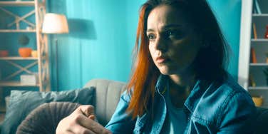 woman sitting up at night terrified of what will happen in the morning