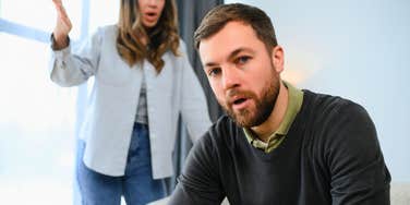 husband feeling hurt by wife who is scolding him