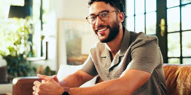 stress-free man relaxing at home creating the reality he wants for himself