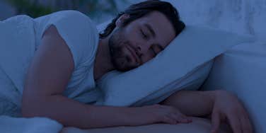 man sleeping peacefully in bed