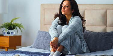 miserable woman waking up in bed starting her morning