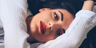 classy woman laying down thinking