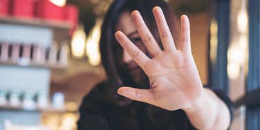 Woman saying no without being rude putting her hand up 