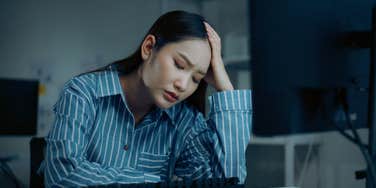 stressed employee sitting at desk in office