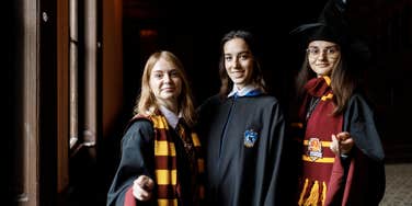 women dressed up like hogwarts students