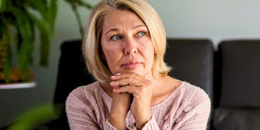 sad baby boomer woman ruminating at home