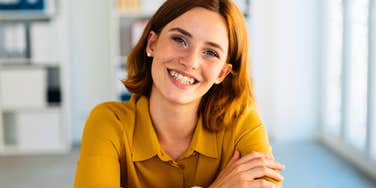gen z woman smiling putting her life skills to use