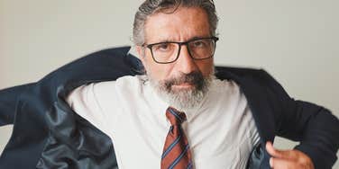 Boomer boss angrily puts on his jacket at work
