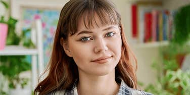 Emotionally strong young woman smiles confidently 