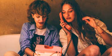 friends in the 1990s playing with landline phone