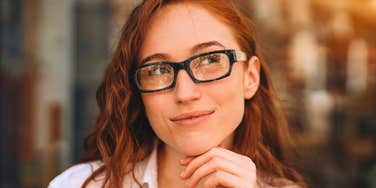 high iq woman deep in thought looking happy
