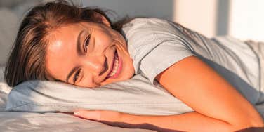 woman waking up happy ready to start the day with morning routine