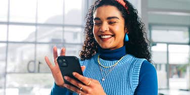 woman with high emotional intelligence smiling at her group chats