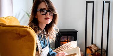 High IQ woman with a book exploring niche interests at home