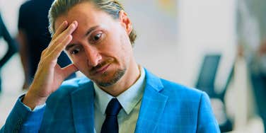 man with a low iq feeling frustrated and stressed at work