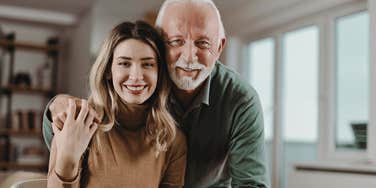 Woman with her older father whom she cherishes at home