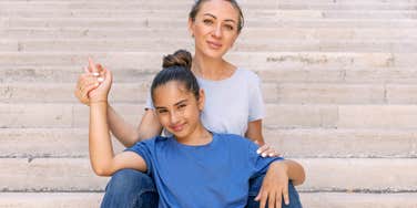 woman whose parents did a great job raising her smiles with her teen daughter