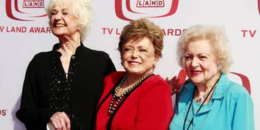 Actresses Bea Arthur, Rue McClanahan, and Betty White smiling together at the 2008 TV Land Awards; a visual representation of 'the archetypal chosen family' and the 'Golden Girls' style living arrangements Millennials are adopting over marriage.
