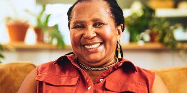 kind woman smiling joyfully at home