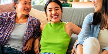sarcastic and honest woman sitting with friends laughing