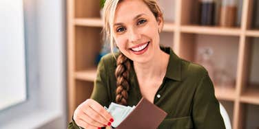 financially responsible woman saving money holding her wallet