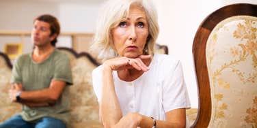 An elderly husband attempting to argue with his wife while she turns away and ignores him; illustrating 'strained communication' and the rigid, unhelpful conflict dynamics common in traditional mid-century partnerships.