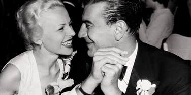 An archival closeup portrait of a cheerful mid-century teenage couple sharing a romantic moment; illustrating 'intentional courtship' and the offline communication skills returning to modern dating.
