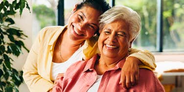 happy adult woman hugging her mom who raised her right