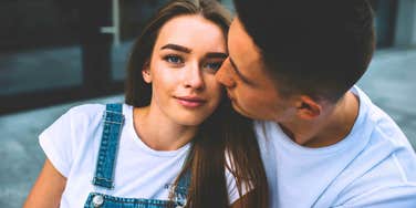 young old-fashioned wife sitting next to doting husband